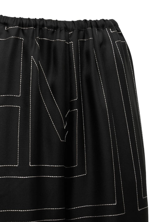 Monogram embroidered black silk pants